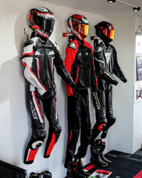 Three PRO V4 moto gear holders installed side by side on a wall